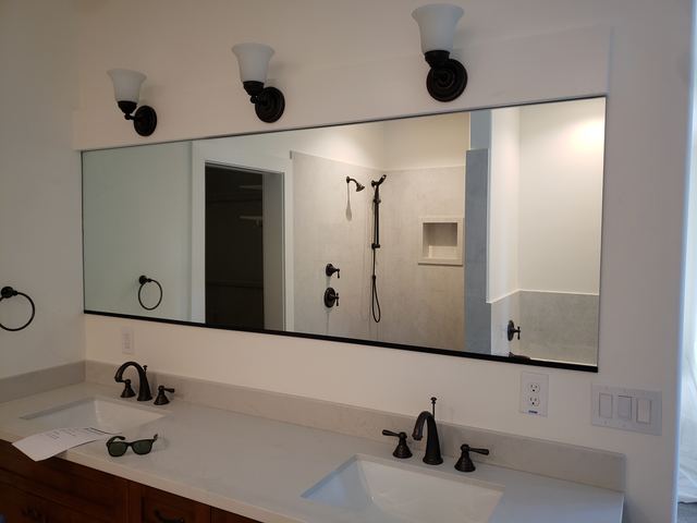 Black-edged vanity mirror over a double sink vanity