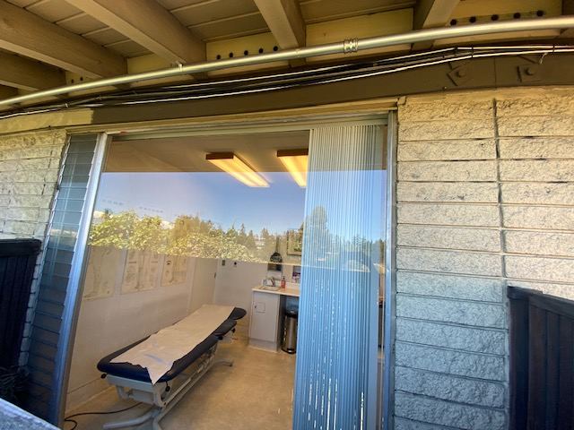 New glass in the window opening with the treatment room visible through it