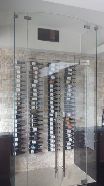 Frameless glass wine room and wall-mounted racks